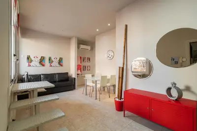a living room with a red couch and a table at Stay U-nique Apartments Torre d'En Damians II in Barcelona