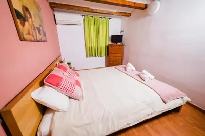a small bedroom with a bed and a television at Rustic Poble Sec Apartment in Barcelona