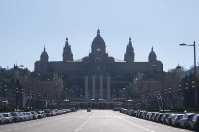 an empty street in front of a large building at Rustic Poble Sec Apartment in Barcelona