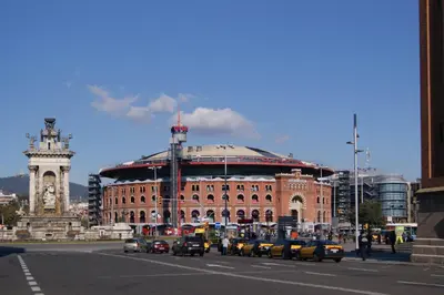 a large building with a clock tower on a city street at Rustic Poble Sec Apartment in Barcelona