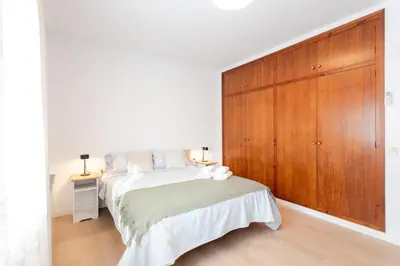 a bedroom with a bed and a large wooden cabinet at Secrets of Montserrat in El Bruc