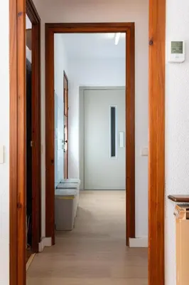 a hallway with a bathroom with a toilet and a door at Secrets of Montserrat in El Bruc
