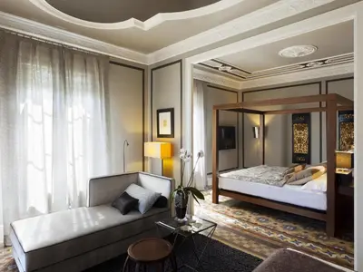 a bedroom with a bed and a large mirror at SuiteaBCN in Barcelona