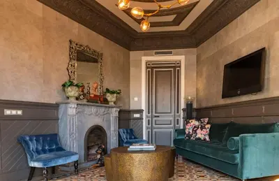 a living room with a couch and a fireplace at SuiteaBCN in Barcelona