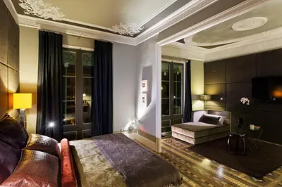 a bedroom with a bed and a couch in a room at SuiteaBCN in Barcelona