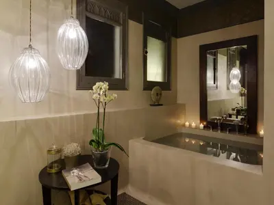 a bathroom with a sink and a vase of flowers on a table at SuiteaBCN in Barcelona