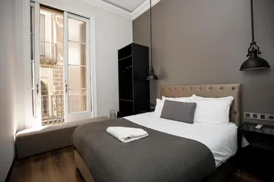 a bedroom with a bed and a window at Classic styled apartment in Barcelona