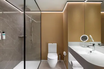 a bathroom with a toilet and a sink and a shower at Labtwentytwo Barcelona, a Tribute Portfolio Hotel in Barcelona
