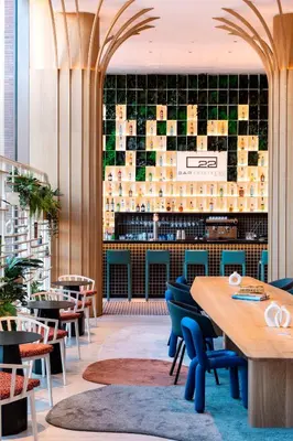 a restaurant with tables and chairs and a bar at Labtwentytwo Barcelona, a Tribute Portfolio Hotel in Barcelona