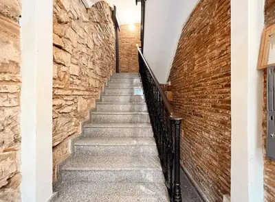 a staircase with a stone wall and a brick wall at Stay U-nique Apartment Ermengarda in Barcelona