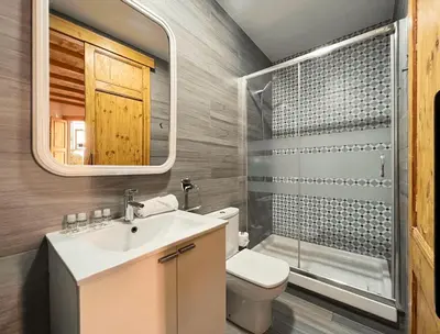 a bathroom with a sink and a toilet and a mirror at Stay U-nique Apartment Ermengarda in Barcelona