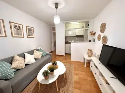 a living room with a couch and a table at Preciosas vistas al mar en Castelldefels in Castelldefels