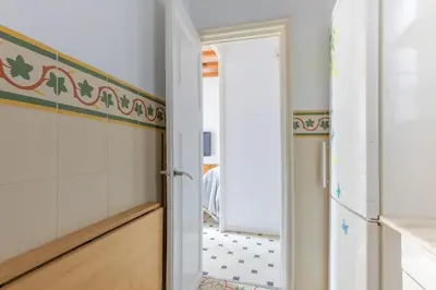 a kitchen with a door leading into a room at Housalia Paseo de Gracia in Barcelona