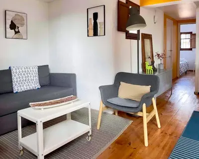 a living room with a couch and a chair at Barcelona Old Town attic near Catalunya square in Barcelona