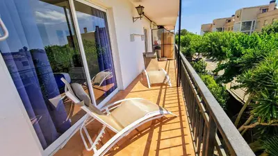 a balcony with two lounge chairs on a house at Apartamento Cabrera Burriac in Cabrera de Mar