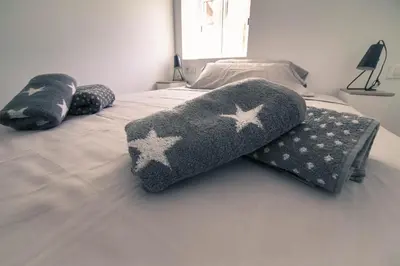 a bed with two pillows on top of it at Apartament Roca Foradada in Monistrol