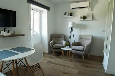 a living room with two chairs and a table at Apartament Roca Foradada in Monistrol