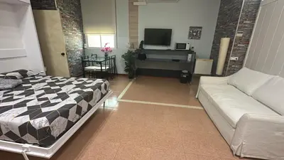 a living room with a bed and a couch at stop & go in Arbós