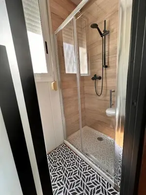 a bathroom with a shower with a glass door at stop & go in Arbós