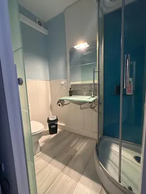 a bathroom with a shower and a sink and a toilet at stop & go in Arbós