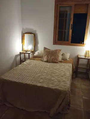a bedroom with a large bed and a window at AMIRA home near Sitges in Sant Pere de Ribes