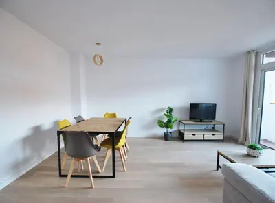 a dining room with a table and yellow chairs at Santa Maria apartment in Vilassar de Mar