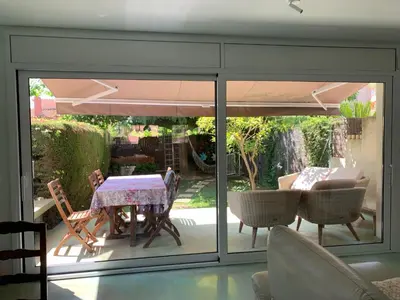 a room with a patio with a table and chairs at Lemon Tree GuestHouse in Tiana
