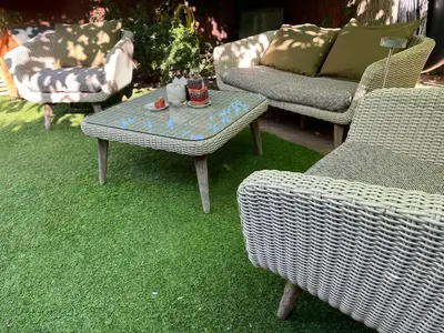 a group of chairs and a table on the grass at Lemon Tree GuestHouse in Tiana
