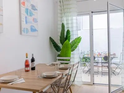 a dining room with a table and a plant at Matarolux24 in Mataró