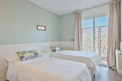 a hotel room with two beds and a window at Luxury Muntaner Plaza in Barcelona
