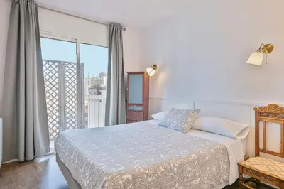 a bedroom with a bed and a large window at Luxury Muntaner Plaza in Barcelona