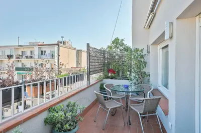 a patio with a table and chairs on a balcony at Luxury Muntaner Plaza in Barcelona