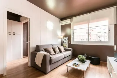 a living room with a couch and a table at Stay U-nique Apartment Parallel in Barcelona