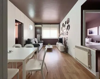 a living room with a couch and a table and chairs at Stay U-nique Apartment Parallel in Barcelona