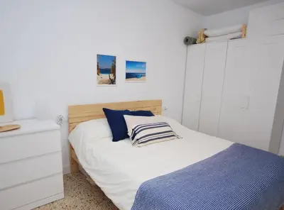 a bedroom with a bed and a white dresser at Can Josep in Vilassar de Mar