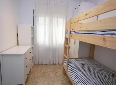 a bedroom with two bunk beds and a desk at Can Josep in Vilassar de Mar