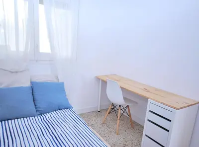 a bedroom with a desk and a bed and a desk and chair at Can Josep in Vilassar de Mar