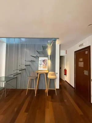 a room with a table and two chairs and a staircase at Maravilloso piso en el corazón de Barcelona in Barcelona