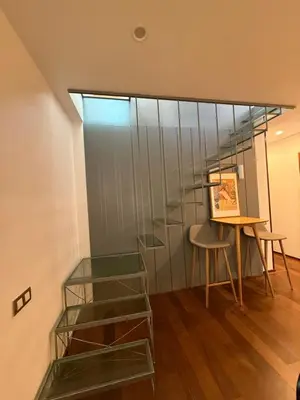 a room with a table and a glass wall at Maravilloso piso en el corazón de Barcelona in Barcelona