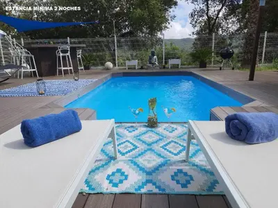 a drink sitting on a table next to a swimming pool at Spa Ibiza Dosrius - Bungalow con Jacuzzi y Piscina privada in Canyamás