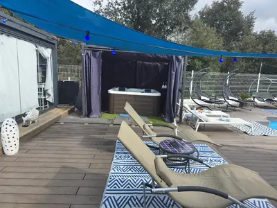 a tent with chairs and a table on a deck at Spa Ibiza Dosrius - Bungalow con Jacuzzi y Piscina privada in Canyamás