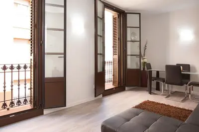 a living room with a couch and a table at APBCN Eixample Center in Barcelona
