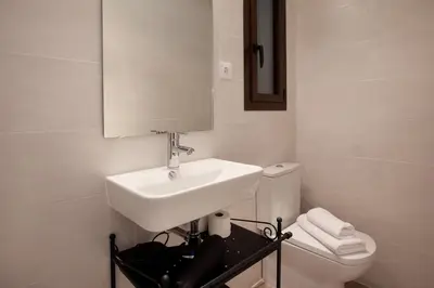 a white bathroom with a sink and a toilet at APBCN Eixample Center in Barcelona
