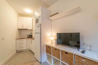 a kitchen with a flat screen tv on a counter at Welcomy Sant Andreu in Barcelona