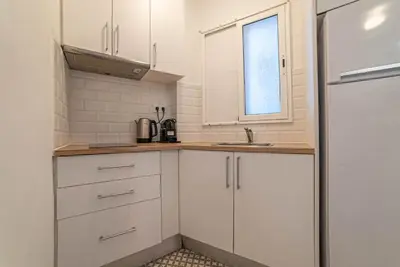 a kitchen with white cabinets and a sink at Welcomy Sant Andreu in Barcelona