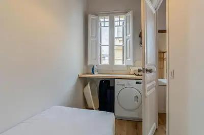 a small kitchen with a washing machine in a room at Canela Homes BARCELONA CÒRSEGA in Barcelona