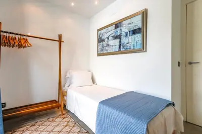 a bedroom with a bed and a picture on the wall at Tranquil large 6 bedroom family Villa sleeps 20 near sitges in Sant Pere de Ribes