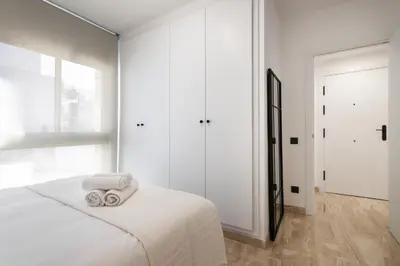a bedroom with a bed with two towels on it at Cozy Apartment Les Corts in Barcelona