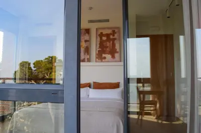 a bedroom with a bed and a view of a room at Circles House Coliving & Coworking in Barcelona