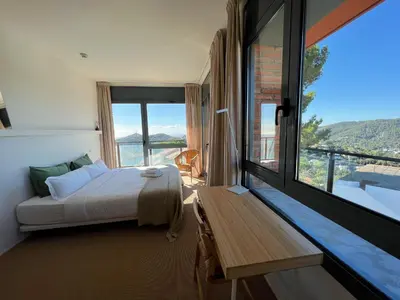 a bedroom with a bed and a large window at Circles House Coliving & Coworking in Barcelona
